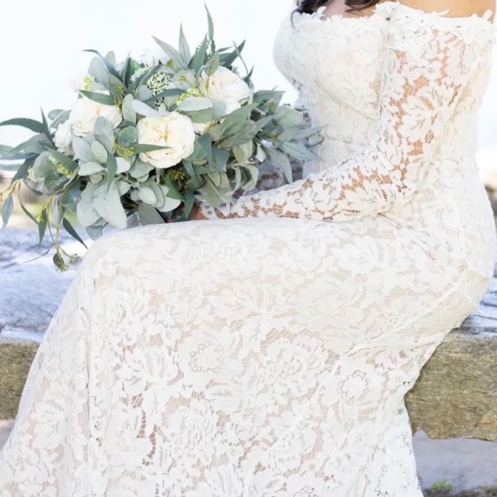 Never worn wedding dress. I’m 5’2 so the front was hemmed to my height!